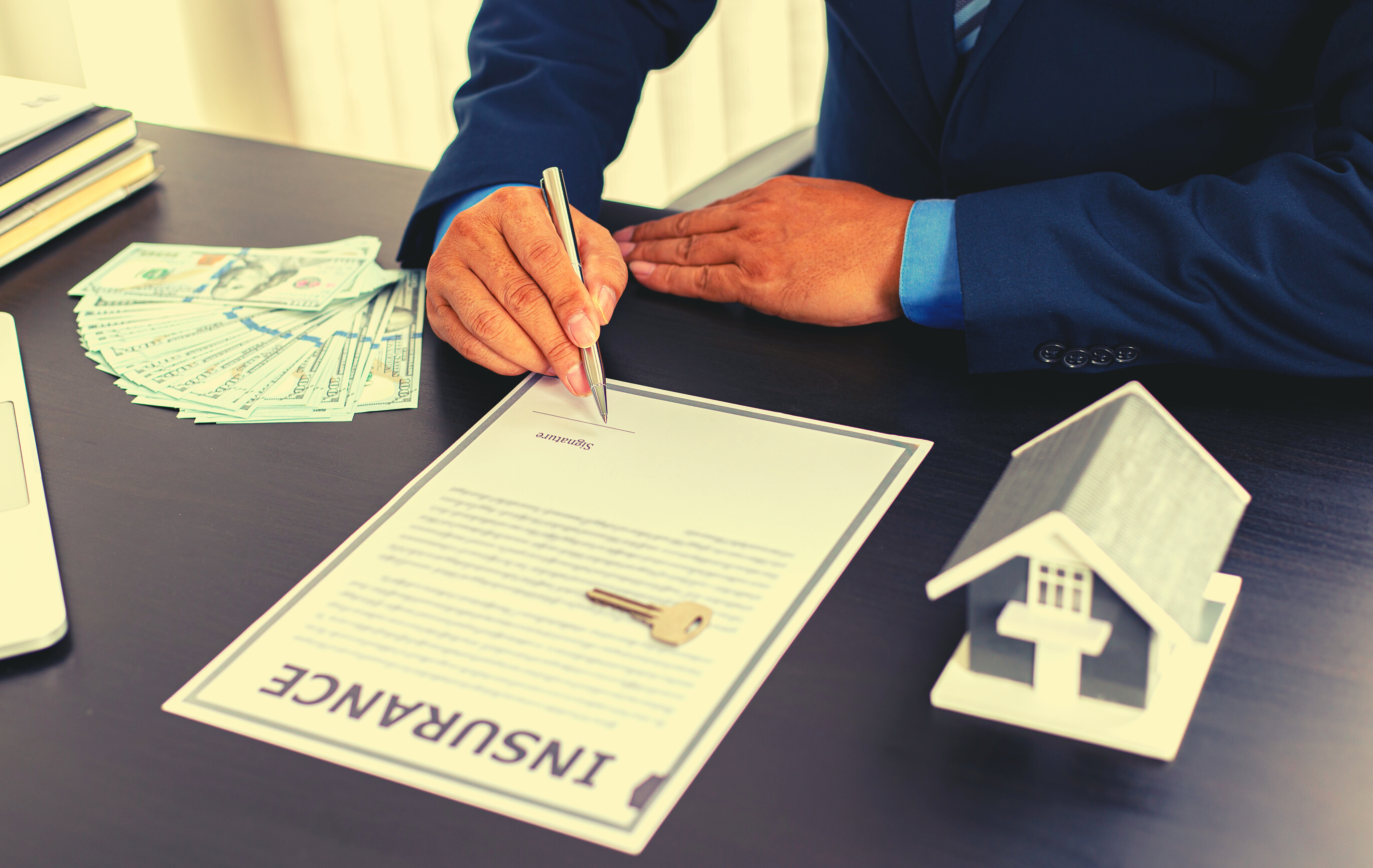 Person Signing Home Insurance Agreement