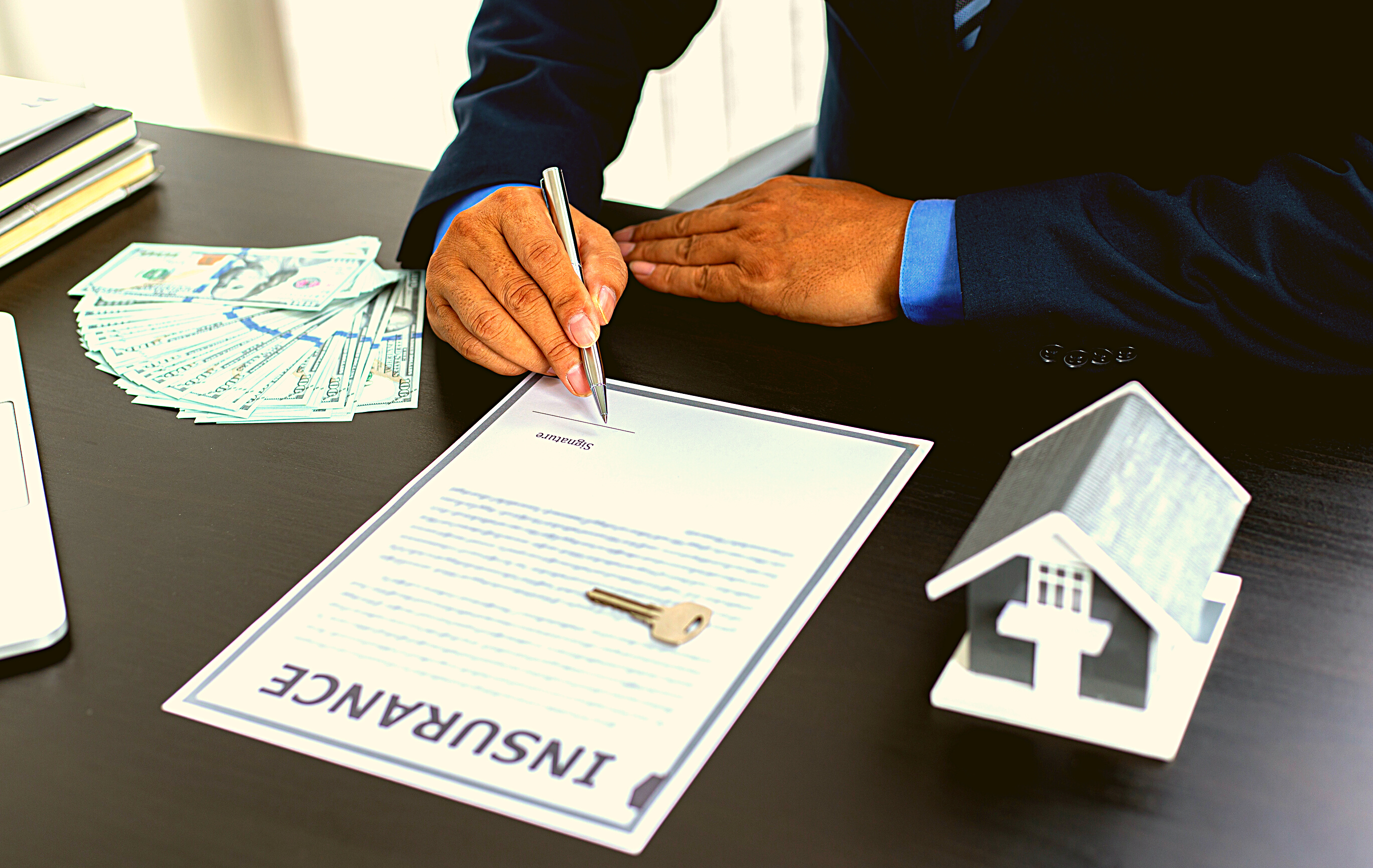 Person Signing Home Insurance Agreement